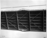 View from below the deck at buckled steel beams WSDOT